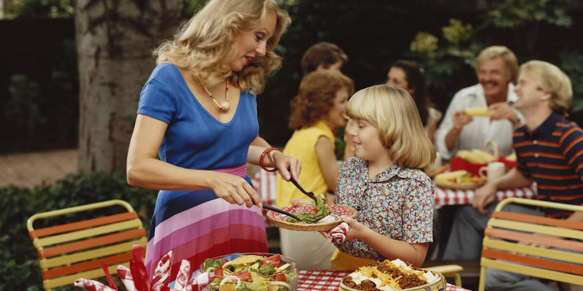 Family eating lunch together outside